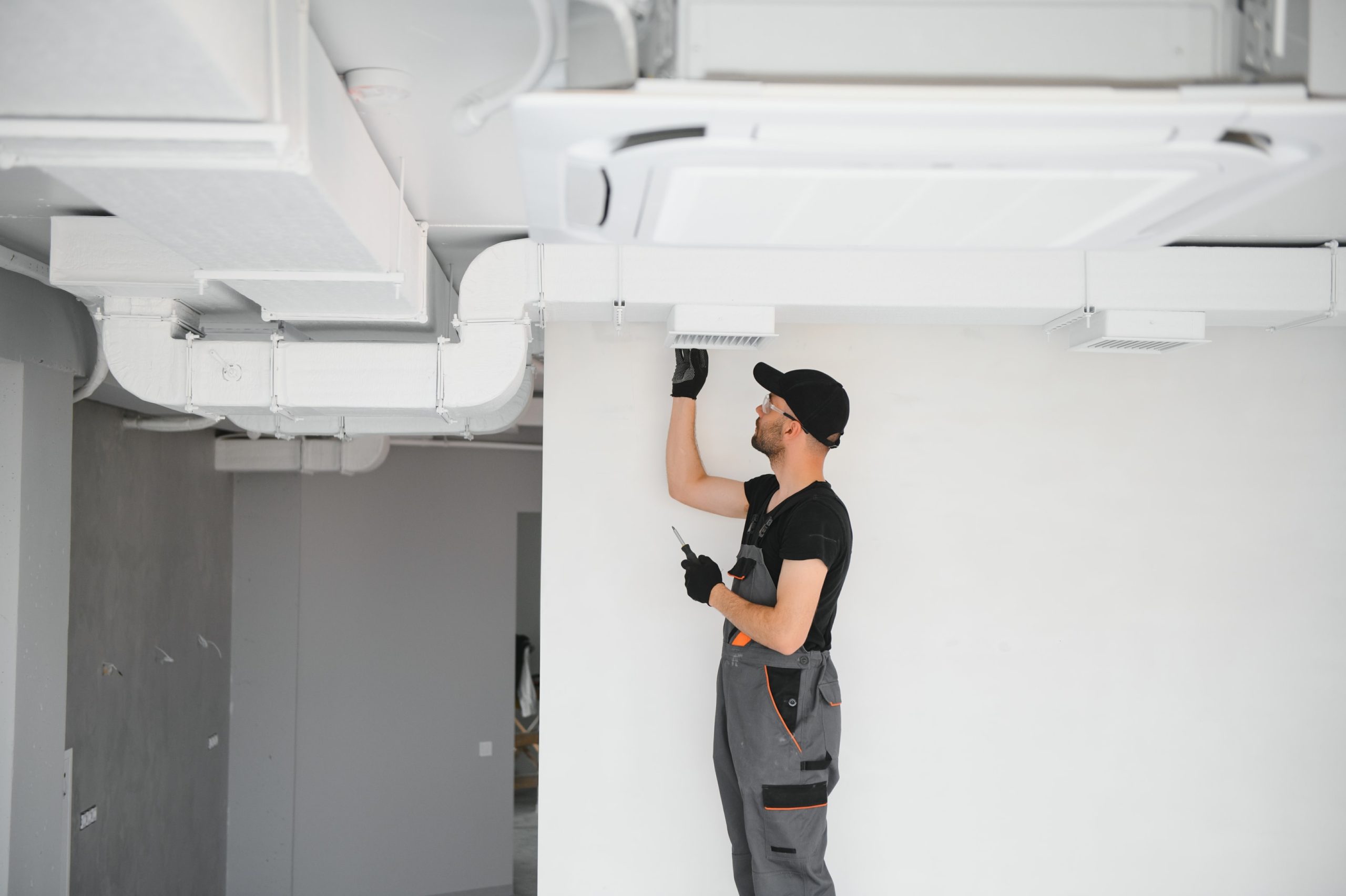 The image depicts a manufacturing facility equipped with a local exhaust ventilation (LEV) system